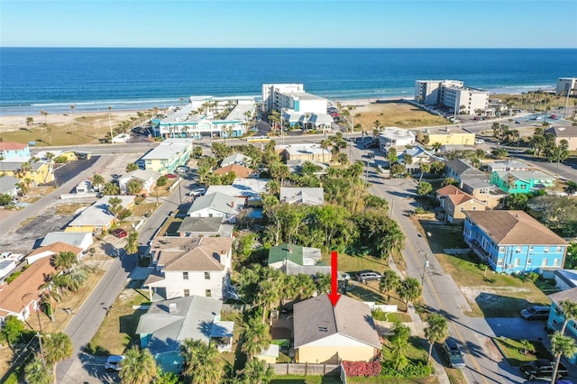 birds eye view of property featuring a water view and a beach view