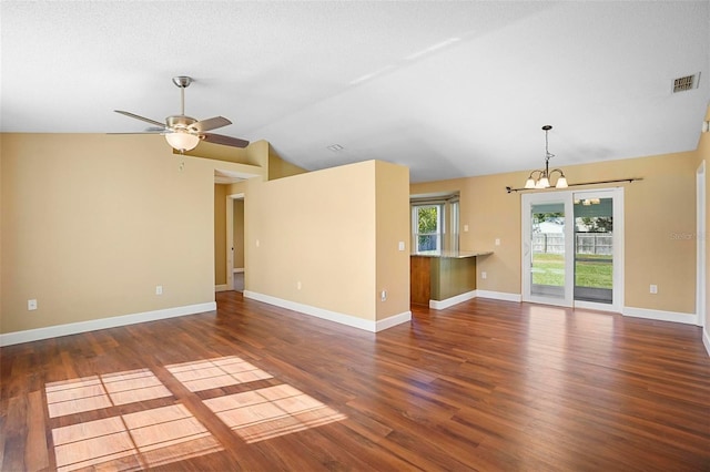 unfurnished living room with a textured ceiling, ceiling fan with notable chandelier, dark hardwood / wood-style floors, and lofted ceiling