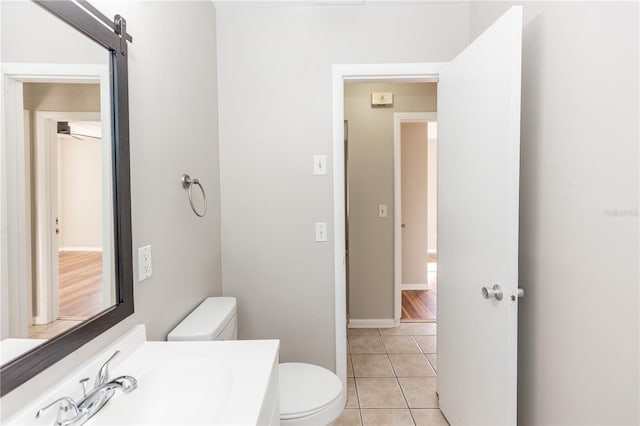 bathroom with tile patterned flooring, ceiling fan, toilet, and vanity