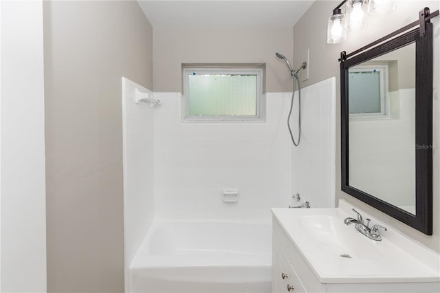 bathroom with vanity and tiled shower / bath