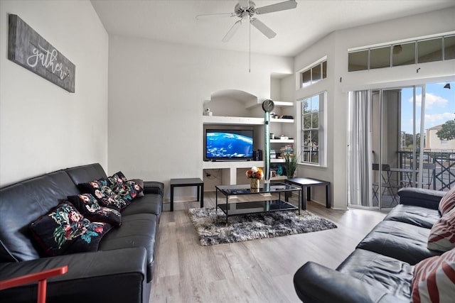 living room featuring hardwood / wood-style floors and ceiling fan