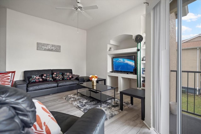 living room featuring ceiling fan and light hardwood / wood-style flooring