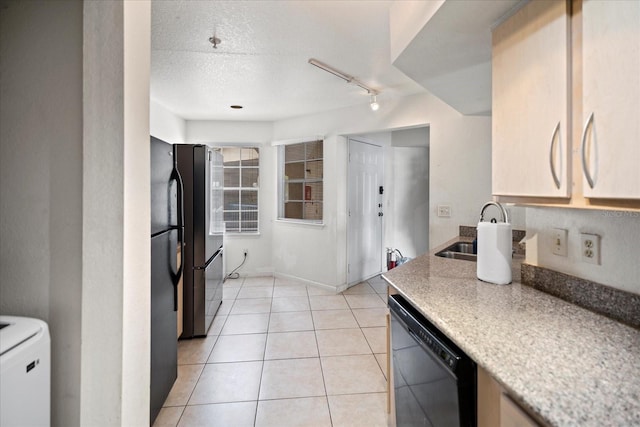 kitchen featuring sink, rail lighting, a textured ceiling, light tile patterned floors, and black appliances