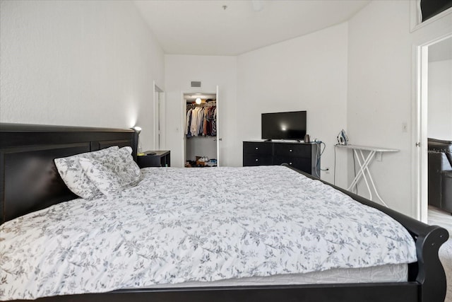 bedroom with a walk in closet and a closet