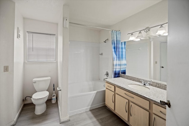 full bathroom with toilet, vanity, hardwood / wood-style flooring, and shower / tub combo with curtain