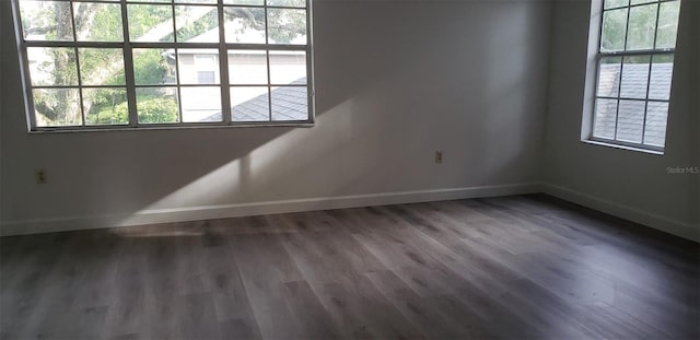 unfurnished room featuring dark wood-type flooring