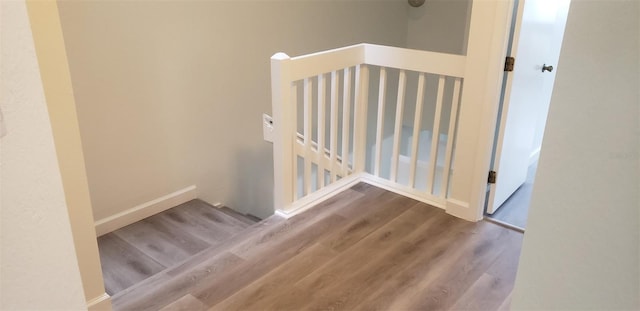 staircase featuring hardwood / wood-style floors