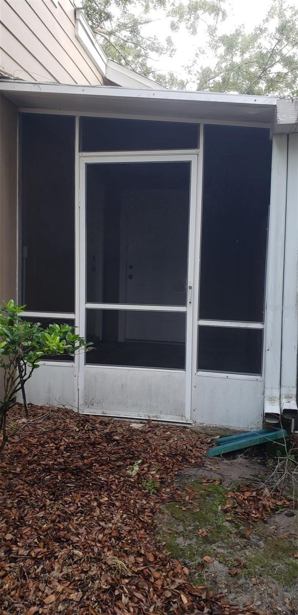 view of property exterior featuring a sunroom