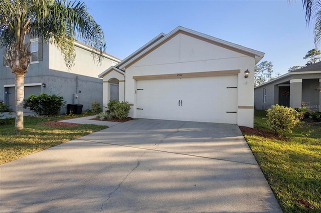 view of front of house with a garage and a front yard