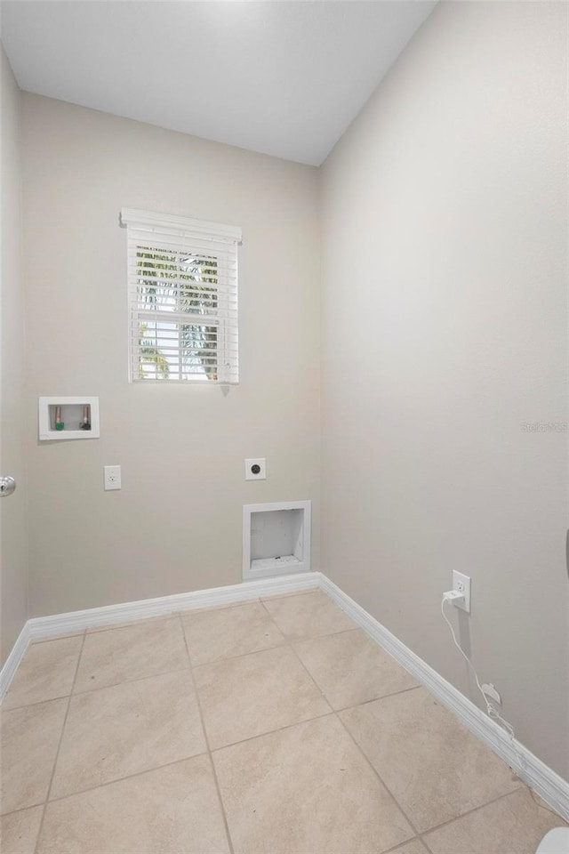 laundry area with hookup for a washing machine, hookup for an electric dryer, and light tile patterned flooring