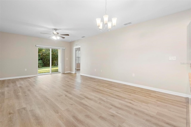 unfurnished room featuring ceiling fan with notable chandelier and light wood-type flooring