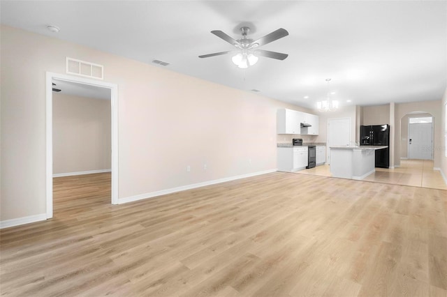 unfurnished living room featuring ceiling fan and light wood-type flooring