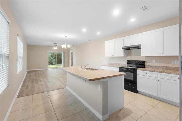 kitchen with light tile patterned flooring, sink, white cabinetry, an island with sink, and black range with electric cooktop