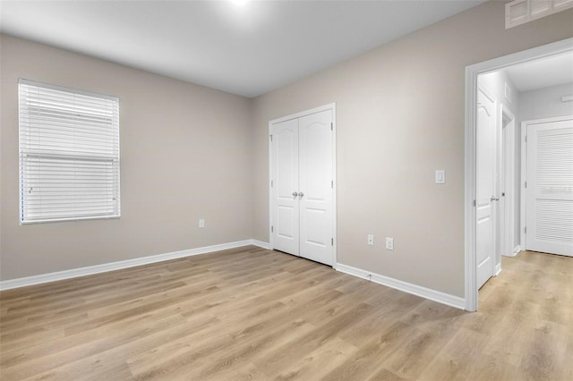 unfurnished bedroom featuring light wood-type flooring