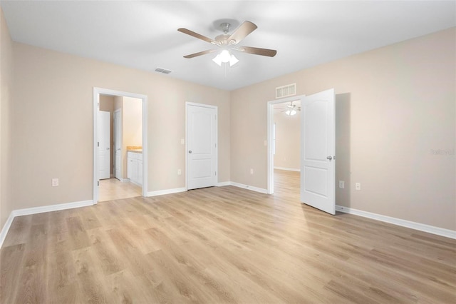 unfurnished bedroom featuring connected bathroom, light hardwood / wood-style floors, and ceiling fan