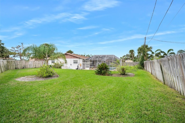 view of yard with glass enclosure