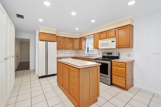 kitchen featuring decorative backsplash, white appliances, sink, and a kitchen island