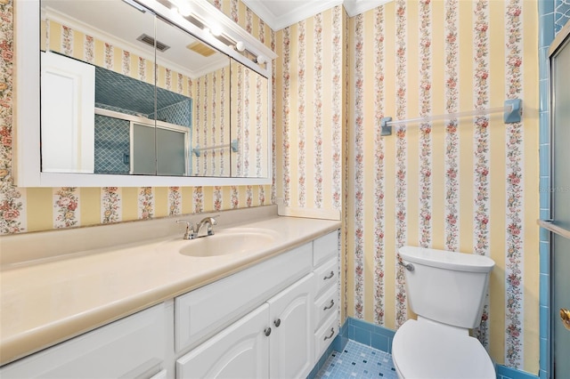 bathroom featuring vanity, crown molding, a shower with shower door, and toilet