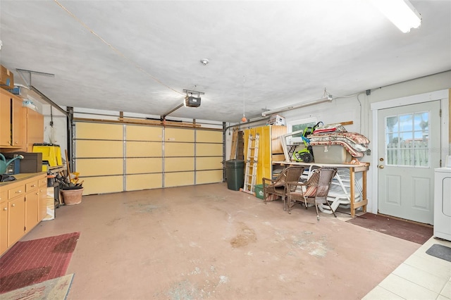 garage with a garage door opener and washer / clothes dryer