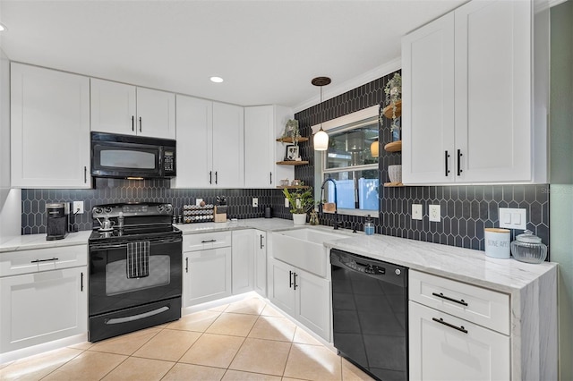 kitchen with black appliances, white cabinets, sink, hanging light fixtures, and ornamental molding