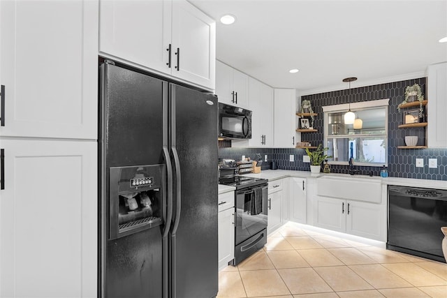 kitchen featuring black appliances, white cabinetry, and sink