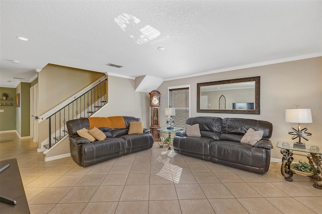 living room featuring crown molding, light tile patterned floors, and a textured ceiling