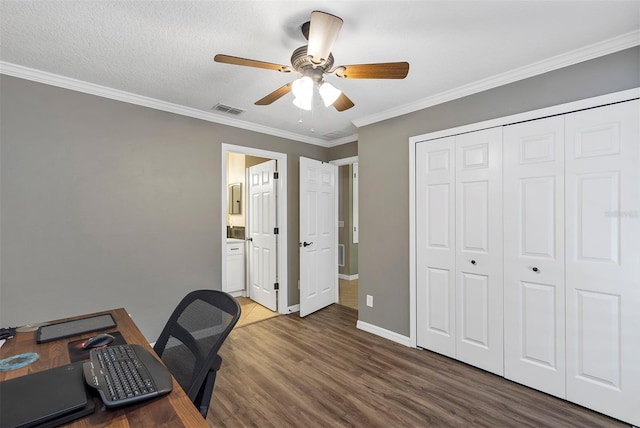 office space featuring a textured ceiling, ceiling fan, ornamental molding, and dark wood-type flooring