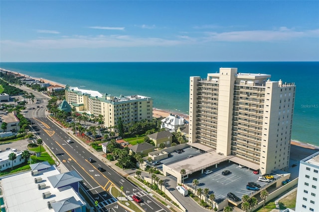 drone / aerial view featuring a water view and a beach view