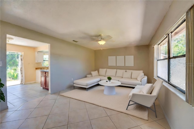 tiled living room featuring ceiling fan and a wealth of natural light