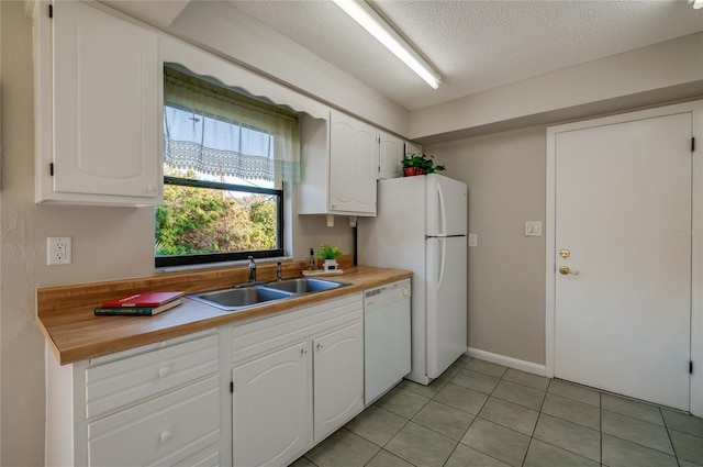 kitchen featuring white cabinetry, sink, and white appliances