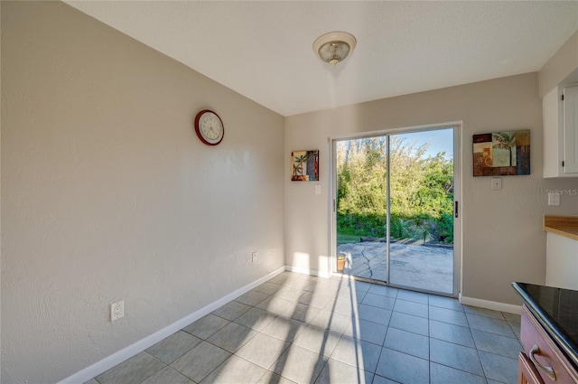 unfurnished dining area featuring light tile patterned flooring