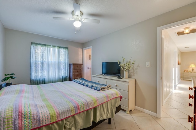 tiled bedroom featuring ceiling fan