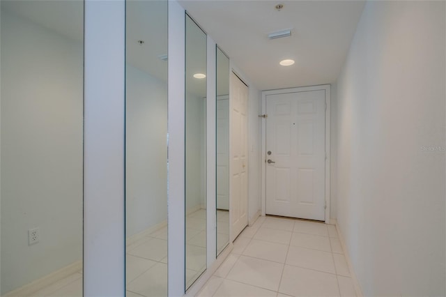 corridor with light tile patterned flooring