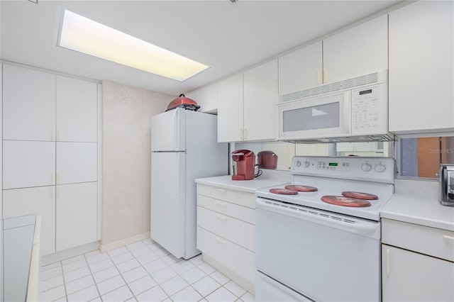 kitchen with white cabinets, white appliances, and light tile patterned flooring