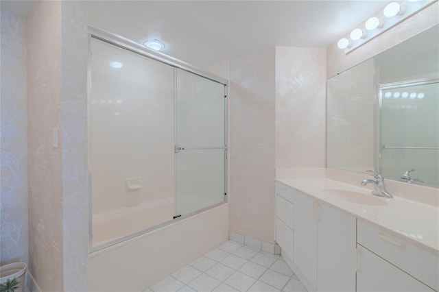 bathroom with tile patterned floors, vanity, and shower / bath combination with glass door