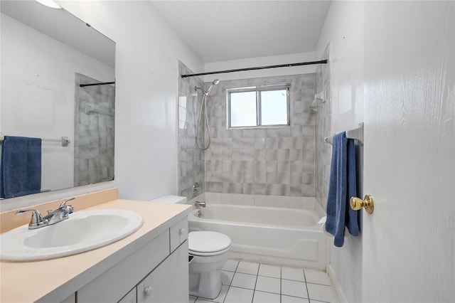 full bathroom with tiled shower / bath combo, tile patterned flooring, a textured ceiling, toilet, and vanity