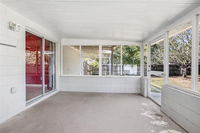 unfurnished sunroom with lofted ceiling and a wealth of natural light