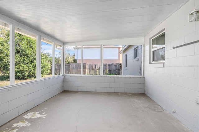 unfurnished sunroom featuring lofted ceiling