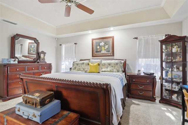 carpeted bedroom featuring multiple windows, ornamental molding, and ceiling fan