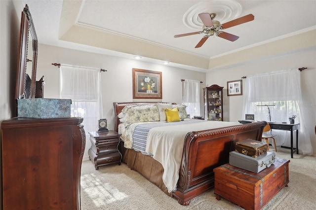 bedroom featuring multiple windows, ceiling fan, and light colored carpet