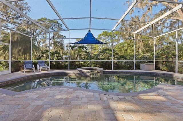 view of pool with a patio area, a lanai, and an in ground hot tub