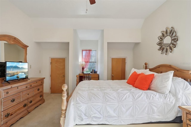 bedroom with ceiling fan, lofted ceiling, and light carpet