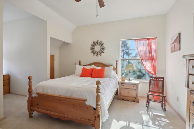 bedroom featuring ceiling fan, light carpet, and vaulted ceiling