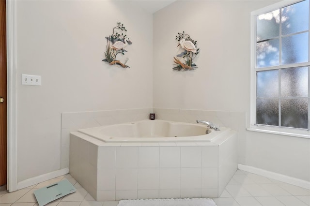 bathroom featuring tile patterned flooring and tiled bath