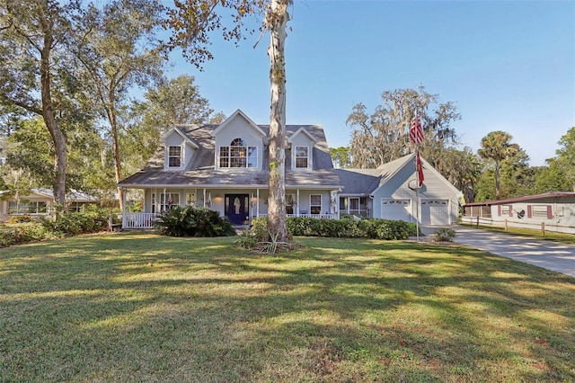 cape cod house featuring a porch, a garage, and a front lawn