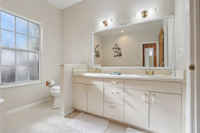 bathroom with tile patterned floors, vanity, and toilet