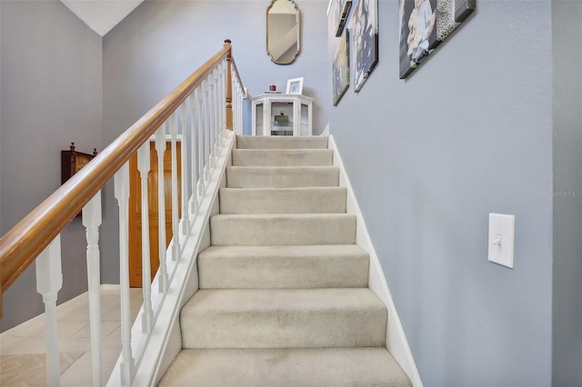 stairway featuring tile patterned flooring