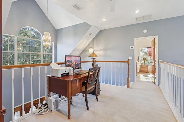 carpeted home office featuring ceiling fan with notable chandelier and lofted ceiling