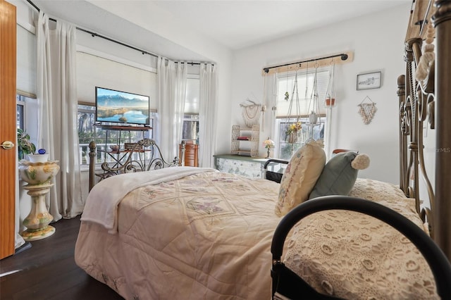 bedroom featuring access to exterior and dark wood-type flooring