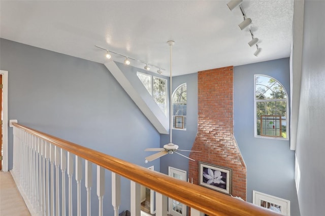 interior space featuring ceiling fan and rail lighting